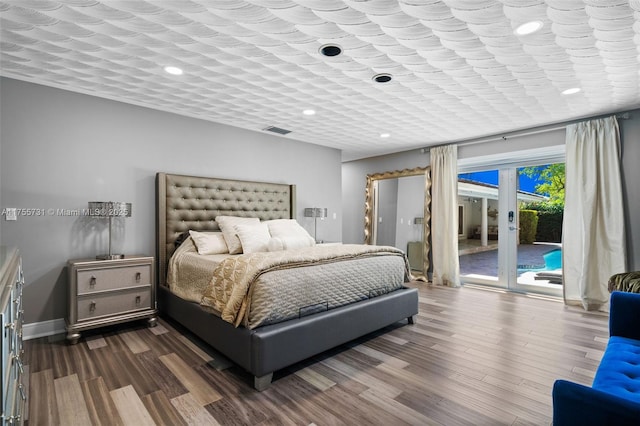 bedroom with visible vents, baseboards, dark wood finished floors, access to exterior, and french doors