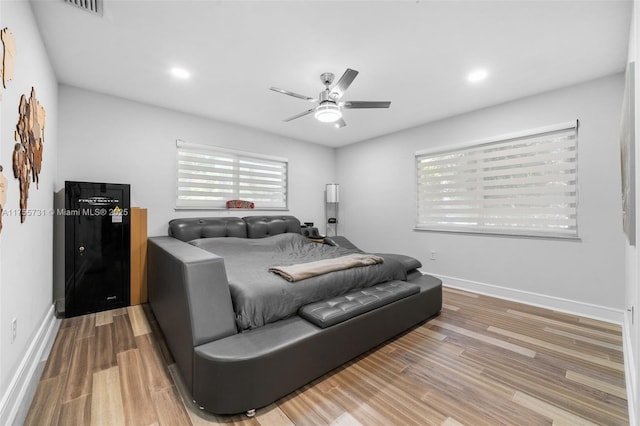 bedroom with recessed lighting, wood finished floors, baseboards, and ceiling fan