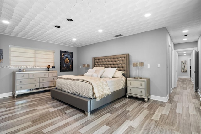 bedroom with recessed lighting, visible vents, baseboards, and light wood-style flooring