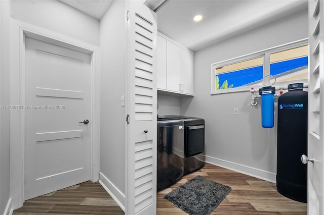 laundry area featuring washer and dryer, wood finished floors, recessed lighting, cabinet space, and baseboards