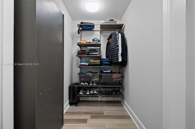 spacious closet with wood finished floors