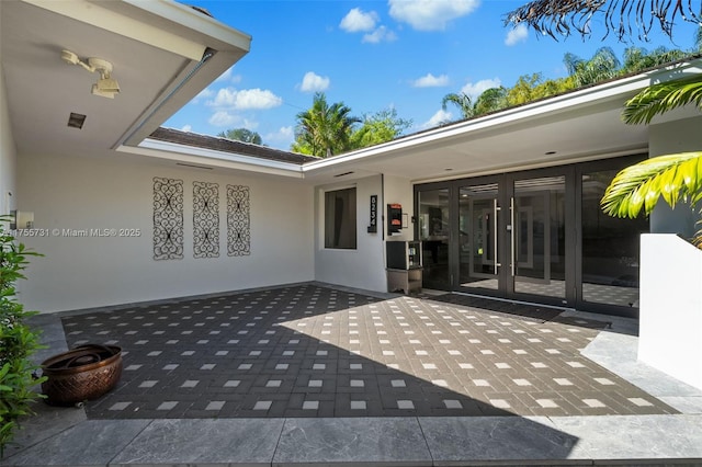 8234 SW 60th Ct, South Miami, FL 33143 - property entrance featuring french doors, a patio area, and stucco siding