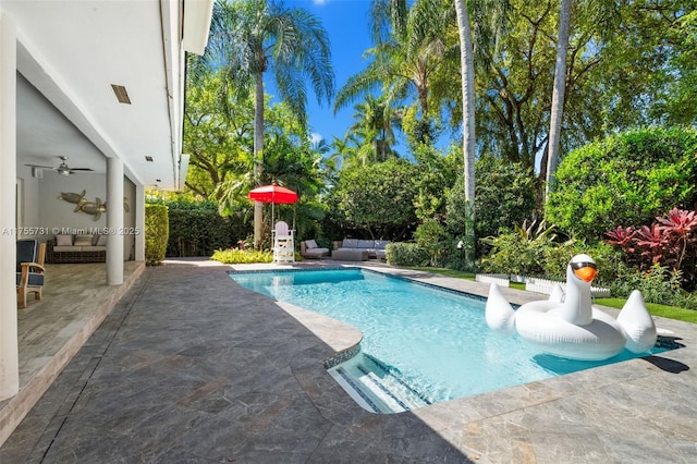 view of swimming pool featuring an outdoor living space, a fenced in pool, and a patio area