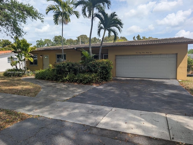 view of front of home featuring stucco siding, driveway, and an attached garage