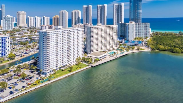 birds eye view of property featuring a city view and a water view