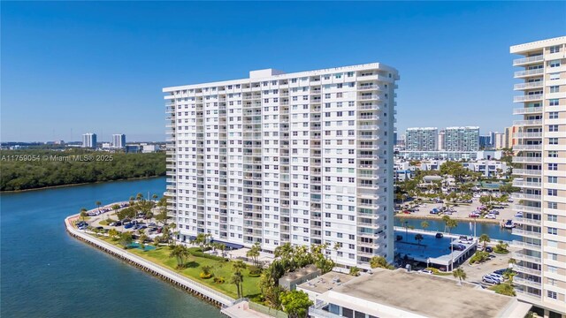 view of apartment building / complex with a city view and a water view