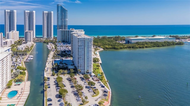 birds eye view of property with a city view and a water view