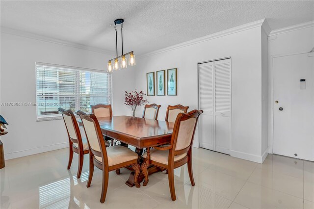 dining space with ornamental molding, a textured ceiling, and baseboards