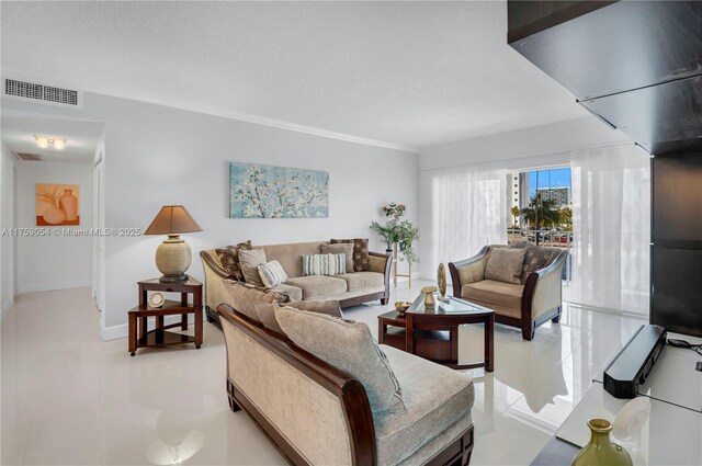 living area with light tile patterned floors and a textured ceiling