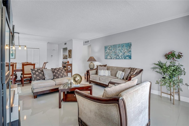 living room featuring visible vents, a textured ceiling, baseboards, and ornamental molding