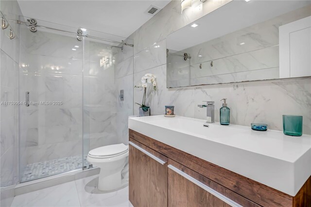 full bathroom with a marble finish shower, toilet, vanity, tile walls, and backsplash