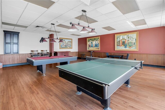 playroom with pool table, a wainscoted wall, a paneled ceiling, wood finished floors, and wooden walls