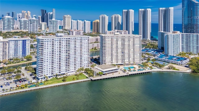 birds eye view of property with a city view and a water view