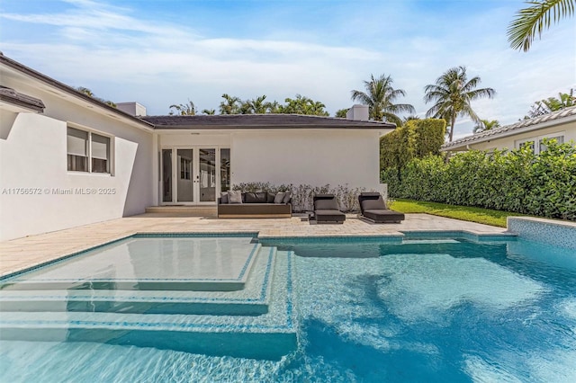 view of swimming pool featuring outdoor lounge area, a patio area, french doors, and a fenced in pool