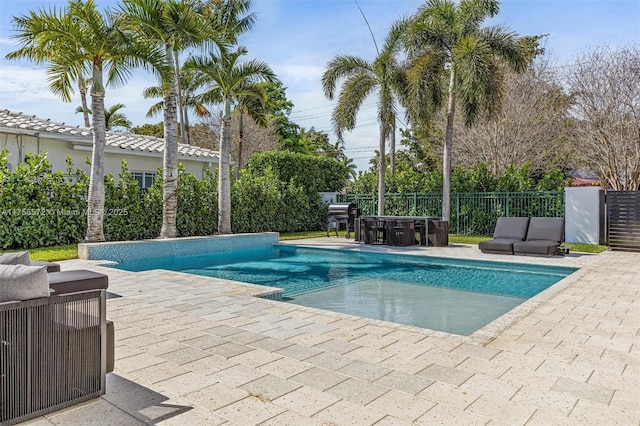 view of swimming pool with a fenced in pool, a patio, and fence