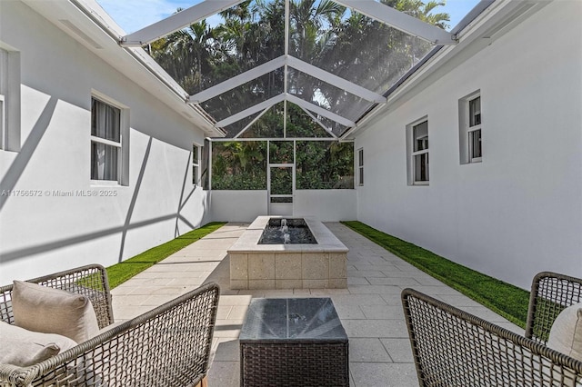 view of patio featuring a lanai and a fire pit