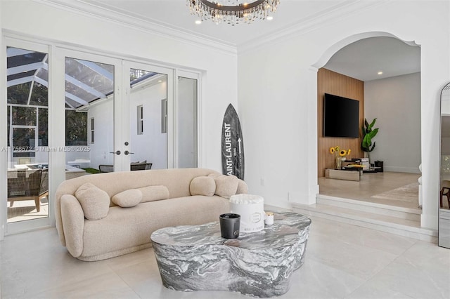 living area with ornamental molding, recessed lighting, french doors, arched walkways, and an inviting chandelier