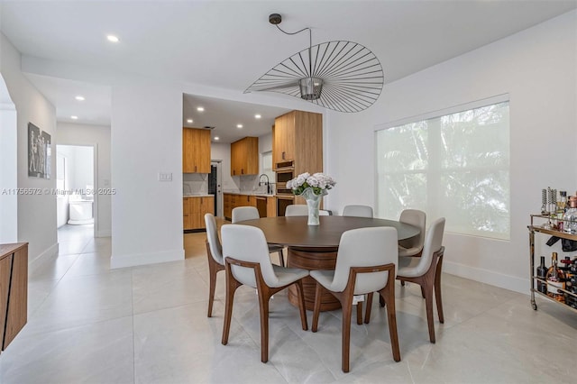 dining room with light tile patterned floors, recessed lighting, and baseboards