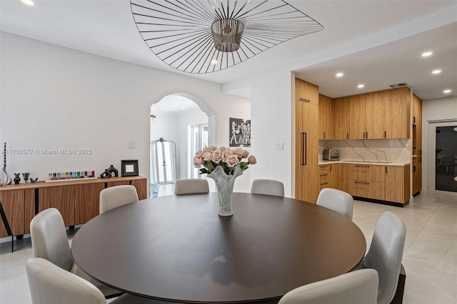 dining room with recessed lighting, visible vents, arched walkways, and light tile patterned floors