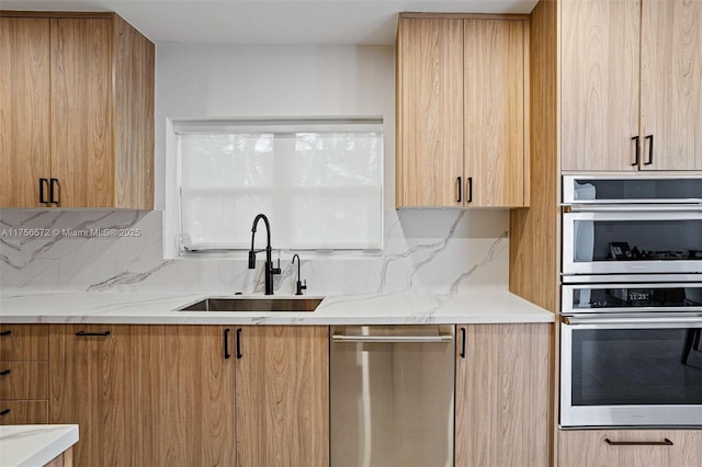 kitchen with decorative backsplash, stainless steel appliances, modern cabinets, and a sink