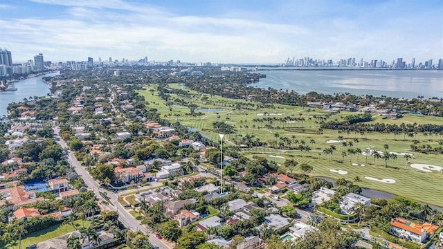 aerial view featuring a view of city, golf course view, and a water view