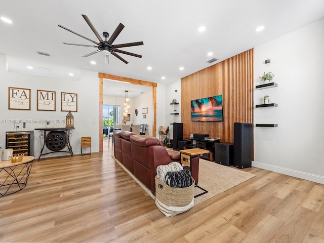 living area with beverage cooler, recessed lighting, light wood-style floors, and visible vents