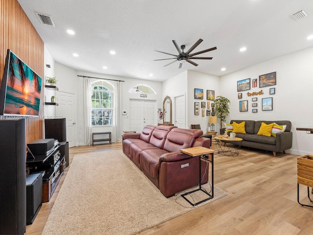 living room with visible vents and light wood-type flooring