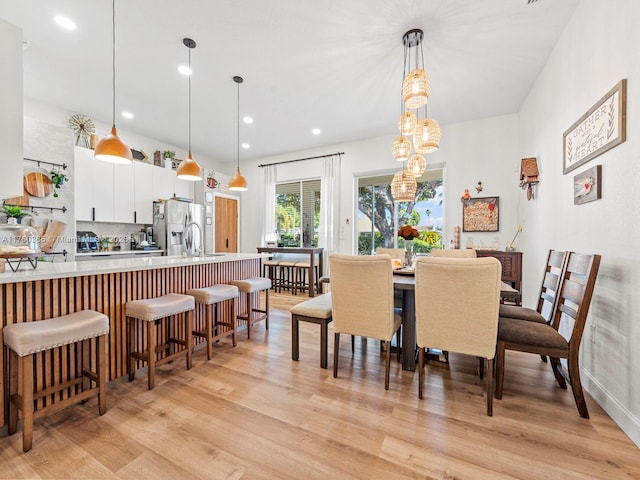 dining space with recessed lighting and light wood-style floors