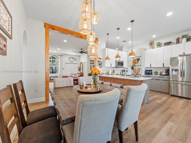 2430 SE 5th Ct, Homestead, FL 33033 - dining area featuring arched walkways, light wood-style floors, ceiling fan, and recessed lighting