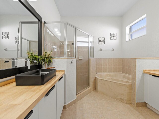 2430 SE 5th Ct, Homestead, FL 33033 - full bathroom with vanity, a bath, a stall shower, and tile patterned floors