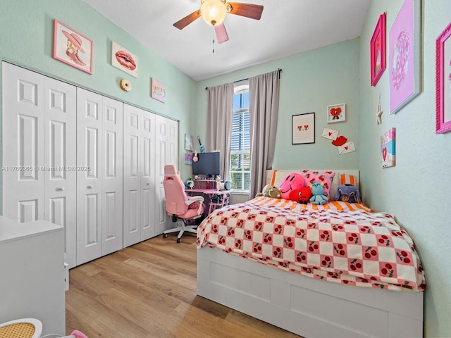 bedroom with a closet, wood finished floors, and a ceiling fan