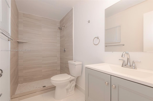 full bath featuring tile patterned flooring, toilet, vanity, and a tile shower