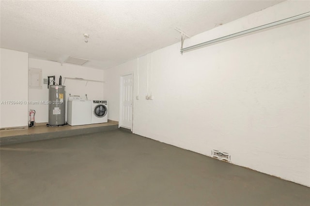 garage featuring washer and dryer and electric water heater