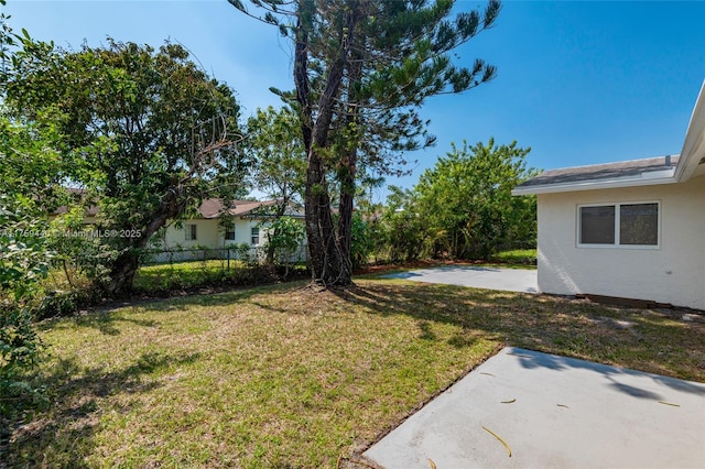 view of yard featuring a patio and fence