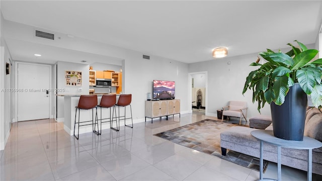 interior space featuring light tile patterned flooring, baseboards, and visible vents