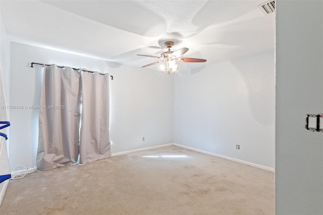 spare room featuring baseboards, carpet, visible vents, and ceiling fan