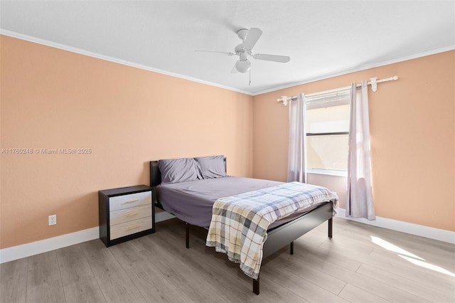 bedroom with light wood-type flooring, baseboards, and crown molding