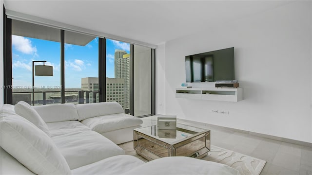 living room featuring a wall of windows and baseboards