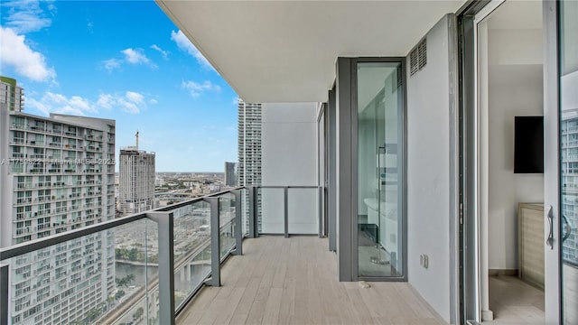 balcony with visible vents and a city view