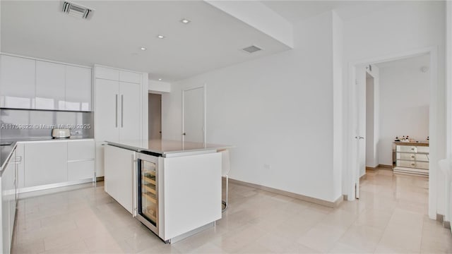 88 SW 7th St Unit 2208, Miami, FL 33130 - kitchen with modern cabinets, white cabinets, a kitchen island, recessed lighting, and light countertops
