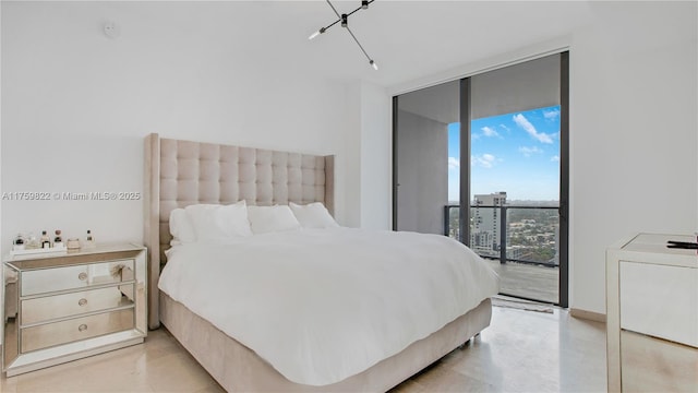 bedroom with access to exterior, floor to ceiling windows, and finished concrete flooring