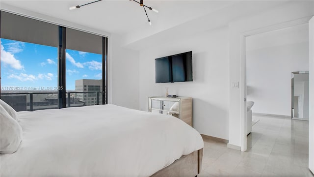 bedroom featuring access to exterior, floor to ceiling windows, and baseboards