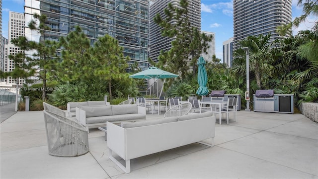 view of patio featuring a city view, an outdoor hangout area, and outdoor dining space