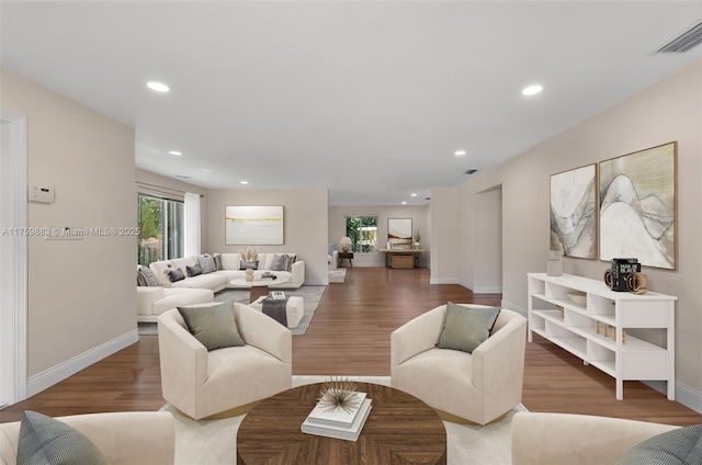 living room with recessed lighting, wood finished floors, visible vents, and baseboards