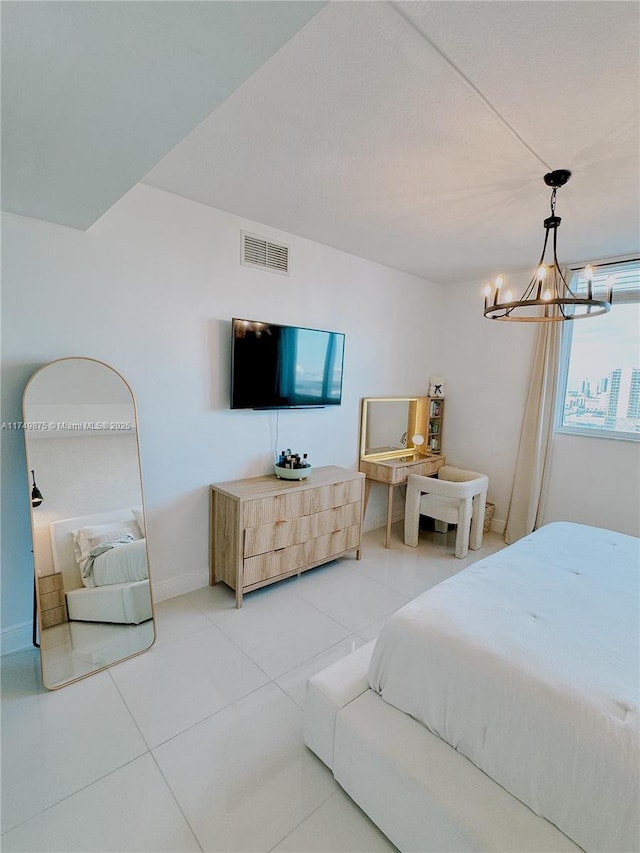 bedroom with light tile patterned floors, visible vents, a chandelier, and baseboards