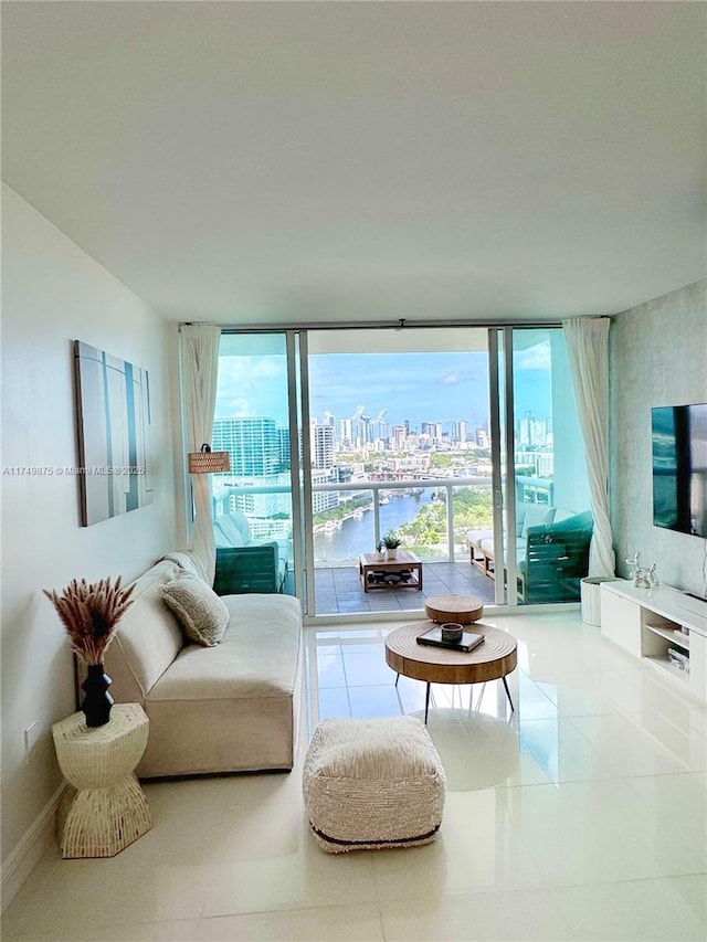 living room with tile patterned floors and floor to ceiling windows