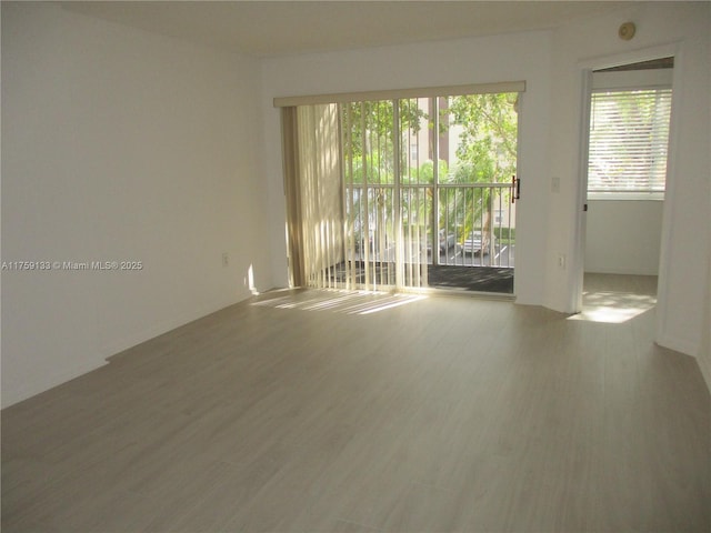 unfurnished room with wood finished floors