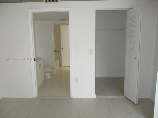 unfurnished bedroom with visible vents and a closet