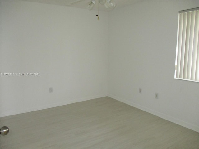 unfurnished room featuring light wood-style flooring and baseboards