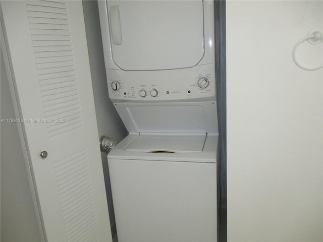 clothes washing area featuring laundry area and stacked washing maching and dryer